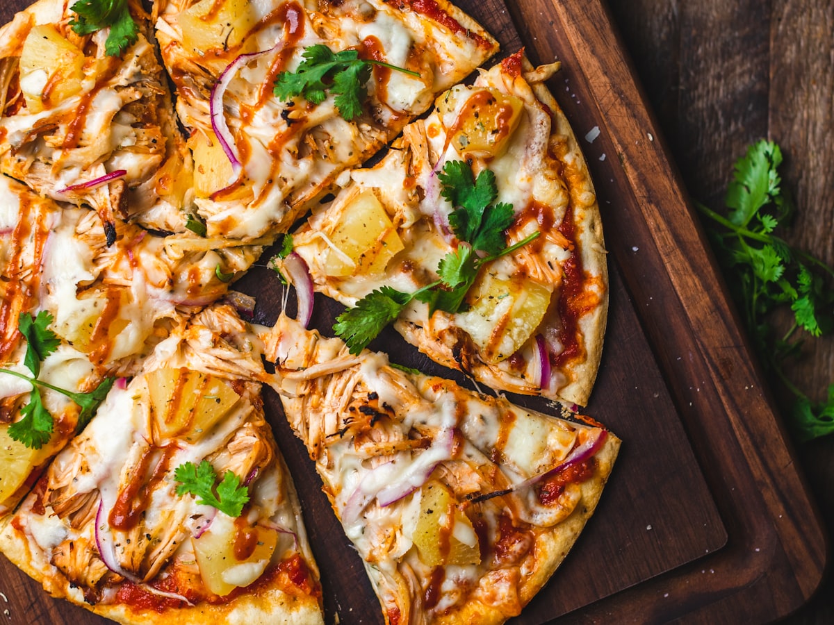 Pizza Diavola mit scharfer Salami auf dunklem Holzbrett